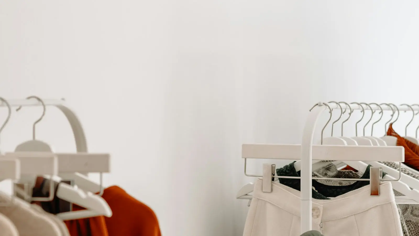 Clothes on a white rack in a boutique
